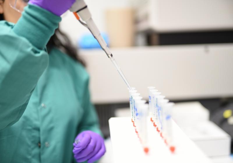 Woman filling tubes in a laboratory